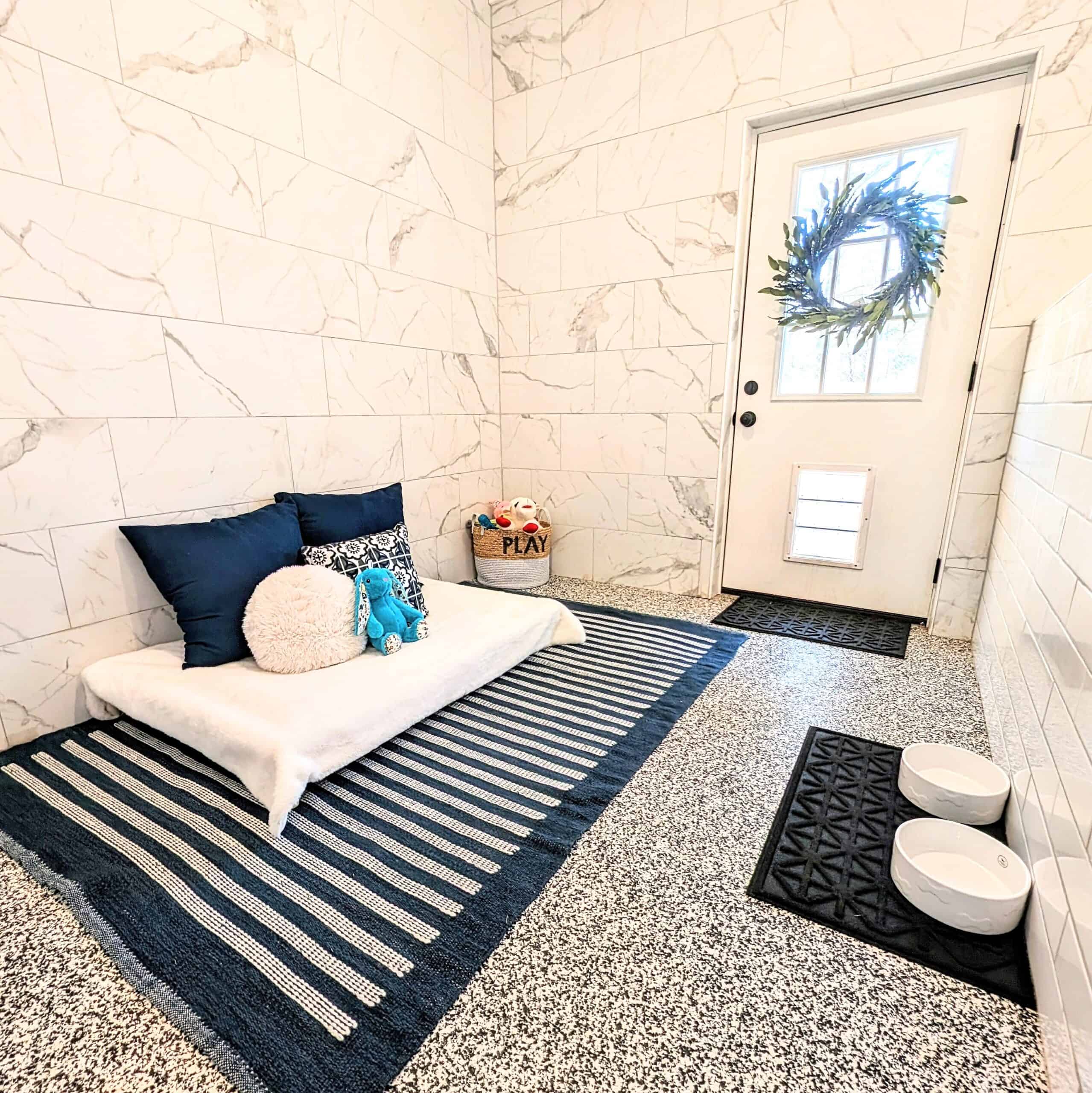Luxury boarding suite with marble walls and plush bedding at Noble Nose Shreveport kennel